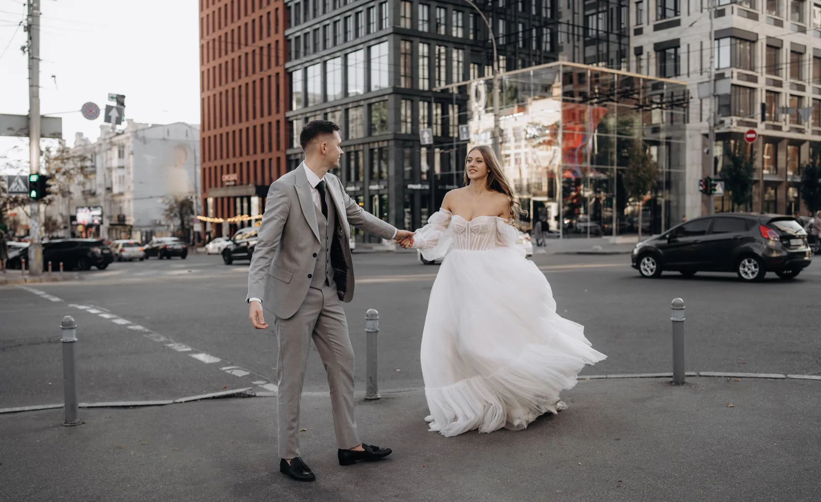 A newlywed couple walking hand in hand