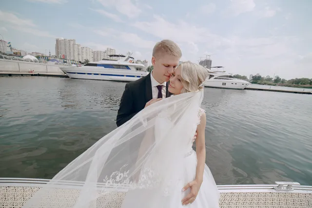 A couple posing near the water