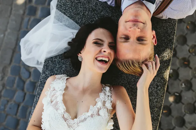 Newlyweds laughing together from above